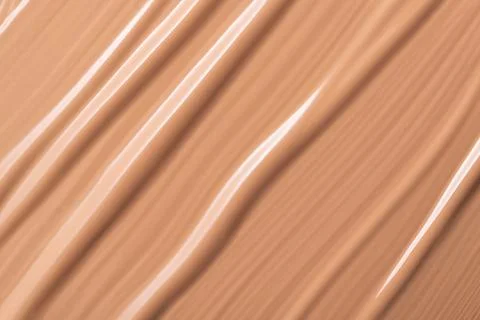 Delicate beige smeared texture of BB face cream, tonal foundation is smudged. Stock Photos