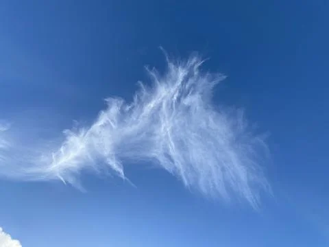 Delicate cirrus cloud in the blue sky Stock Photos