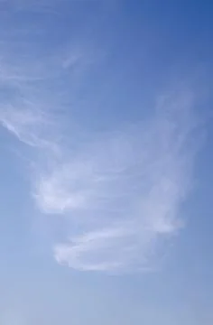 Delicate Cirrus Cloud Formation in Bright Blue Sky Vertical Nature Background Stock Photos
