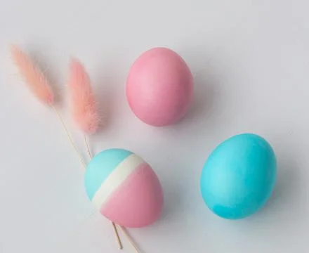 Delicate colors of Easter eggs on a white table, top view Stock-Fotos