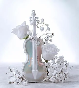 Delicate composition with artificial violin and white flower buds Stock Photos