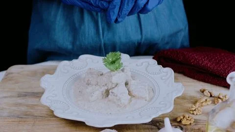 Delicate culinary presentation: coating cooked duck with satsivi 스톡 사진