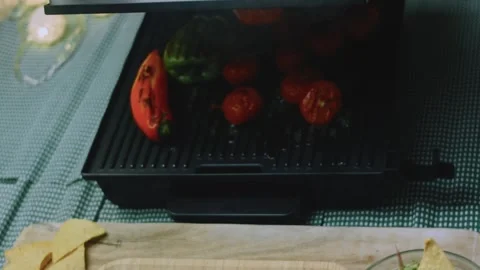 Delicate culinary view of glossy tomatoes developing grill marks Stock Footage 342152703