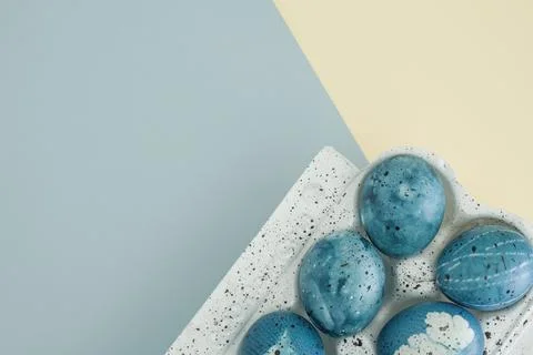 Delicate Easter composition with Easter eggs in blue colors in a white egg Stock Photos