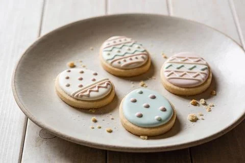 Delicate Easter egg shaped cookies with pastel icing and intricate designs .. Stock Photos