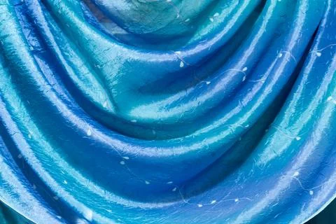 Delicate fabric bends on the wall arc blue Stock Photos