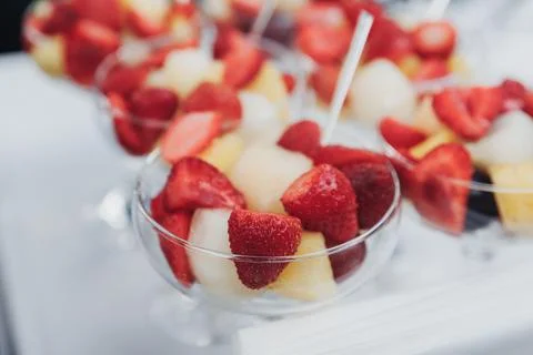 Delicate fruit cups gleam under soft light Foto stock