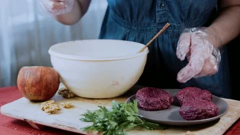 Delicate garnished dish view: pressing walnut garnish into each portion Stock Photos