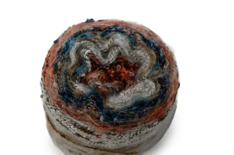 Delicate hand-spun wool craft showcases swirling patterns and vibrant color.. Stock Photos