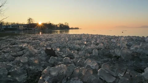 Delicate ice balls form on the grass Balaton lake in winter sunset Video stock 326321338