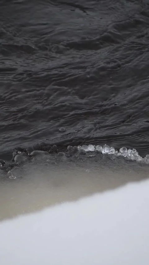 Delicate Ice Spheres and Crystals on a Dark Winter River Edge - Small Round Ice Stock Footage 326216360