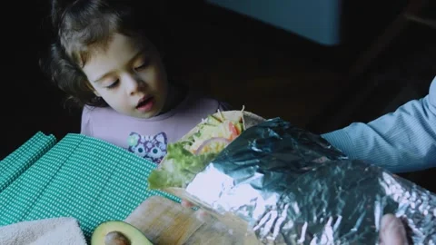Delicate ingredient view: child tasting a homemade burrito Stock Footage 342168372
