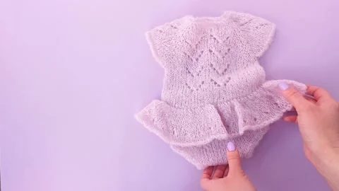 Delicate knitted pink combez with ruffles on the baby Stock Footage 236560155