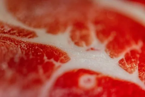 The delicate marbled texture of bright red frozen pork slices Stock Photos