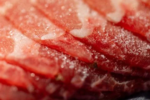 The delicate marbled texture of bright red frozen pork slices Stock Photos
