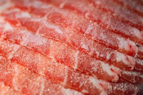 The delicate marbled texture of bright red frozen pork slices Stock Photos