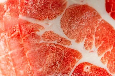 The delicate marbled texture of bright red frozen pork slices Stock Photos
