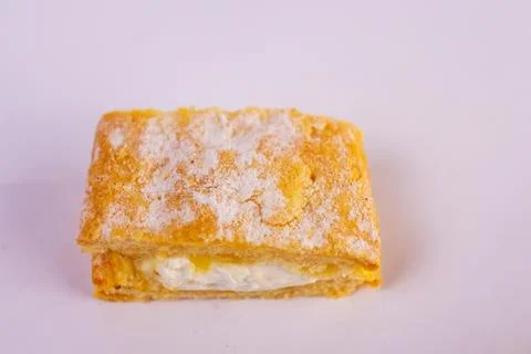 Delicate mille-feuille bite-sized pastry, showcasing golden puff pastry layers Stock Photos