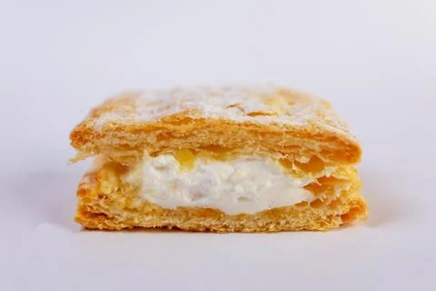 Delicate mille-feuille bite-sized pastry, showcasing golden puff pastry layers Stock Photos