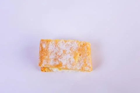 Delicate mille-feuille bite-sized pastry, showcasing golden puff pastry layers Stock Photos