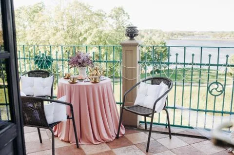 Delicate morning tea table setting with lilac flowers in Nesvizh castle, anti Stock Photos