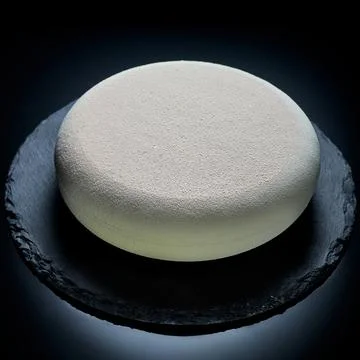 Delicate mousse cake with ground coffee beans and hazelnuts on a dark backgro Foto stock