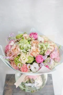 Delicate, pastel coloured Small Beautiful bouquet of mixed flowers. Floral shop Stock Photos