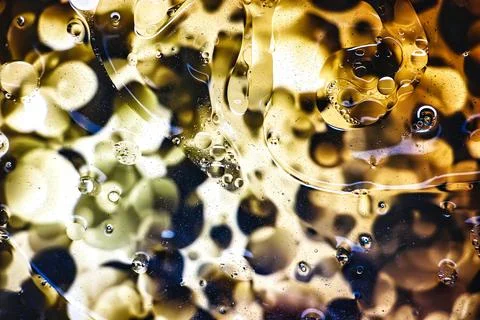 Delicate patterns of bubbles and colors captured under the lens of a microsco Stock Photos