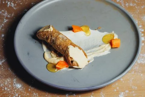 Delicate presentation of bread and vegetables on a gray plate Stock Photos