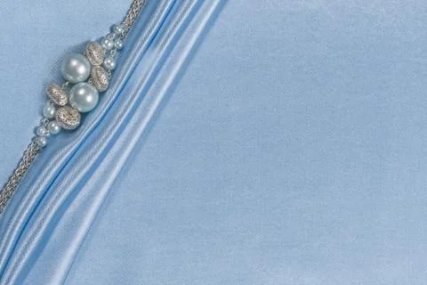 Delicate satin background with beads Stock Photos