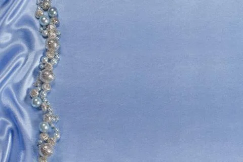 Delicate satin background with beads Stock Photos