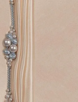 Delicate satin background with beads Stock Photos