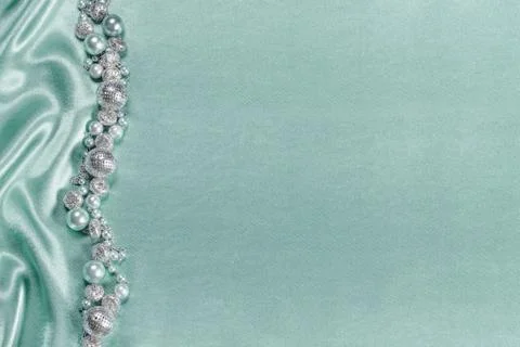 Delicate satin background with beads Stock Photos