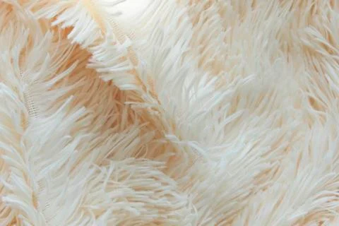 Delicate soft background of plush fabric folds on white background. Copy space Stock Photos