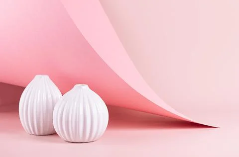 Delicate spring pink interior with ribbed white ceramic vases on soft light p Stock Photos