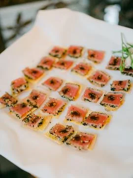 Delicate sushi bites served elegantly on a white platter during a catered event Stock Photos