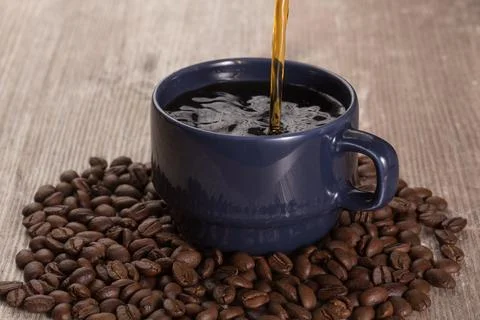 Delicate table with a full cup of coffee Stock Photos