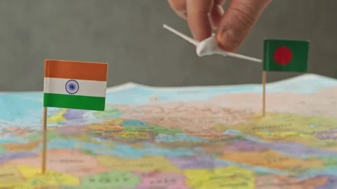 Delicate tiny airplane traverses bright map adorned with respectful flags and Video stock 326064656