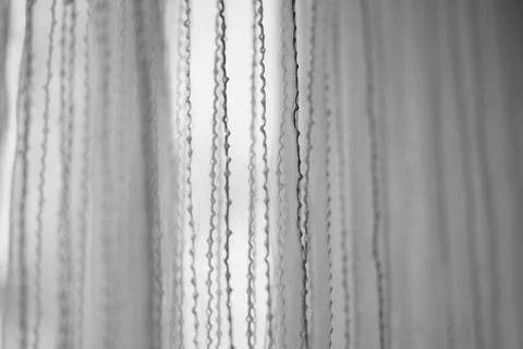 Delicate tulle with vertical threads pattern, side view, bw photo. 스톡 사진