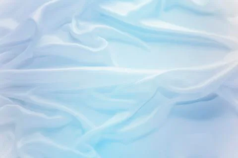 Delicate waves of blue satin silk close up Stock Photos