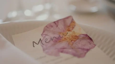 Delicate wedding menu card with pressed flower detail Stock Footage 321453574