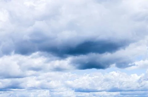 Delicate wispy multicolor clouds with a blue sky Stock Photos