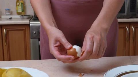 Delicately Extracting Eggshell From Boiled Egg Using Careful Hand Movements Stock-Footage 328495669