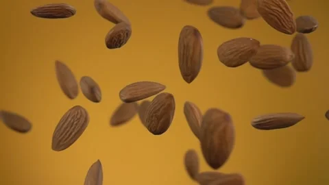 Delicious almonds are bouncing and rotating on the yellow background Stock Footage 148870438