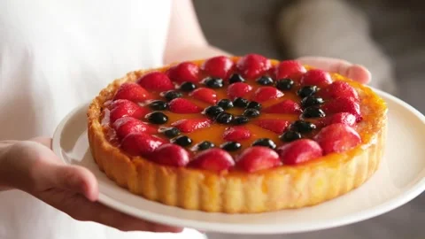 Delicious and appetising cheesecake in the hands of a man , white background Stock Footage 282963149