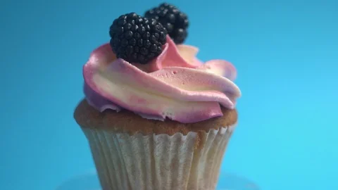 A delicious and appetizing capkake with a pink filling rotates with two Stock Footage 92684256