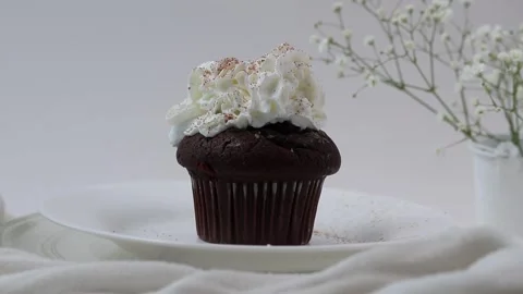 Delicious and appetizing dessert, chocolate cup cake on a white plate and Stock Footage 344881617