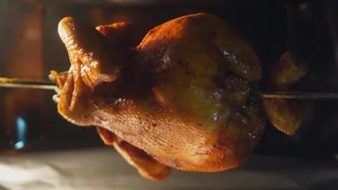 Delicious and appetizing grilled chicken rotates slowly in the oven Stock Footage 150634932