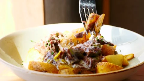 A Delicious and Appetizing Plate of Meat and Potatoes Served in a Beautiful Stock Footage 307996800