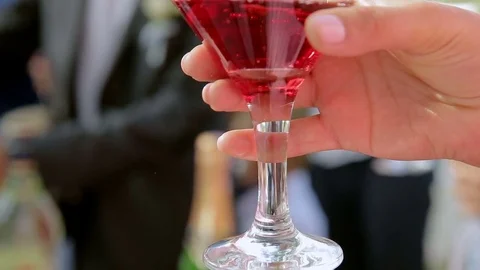 A delicious and drunk cocktail in the hands of a woman at a celebration Stock Footage 77002610
